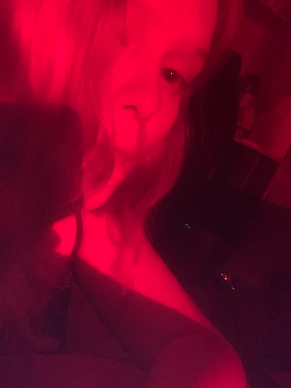 Red-lit portraits and prop sword documented in Russian suburb