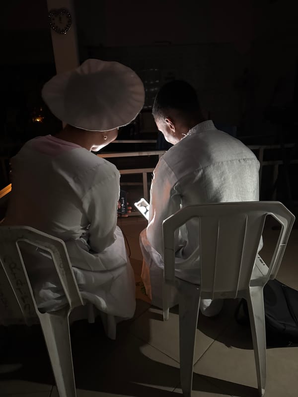 Nighttime ceremonial gathering in white attire, Badagry Nigeria