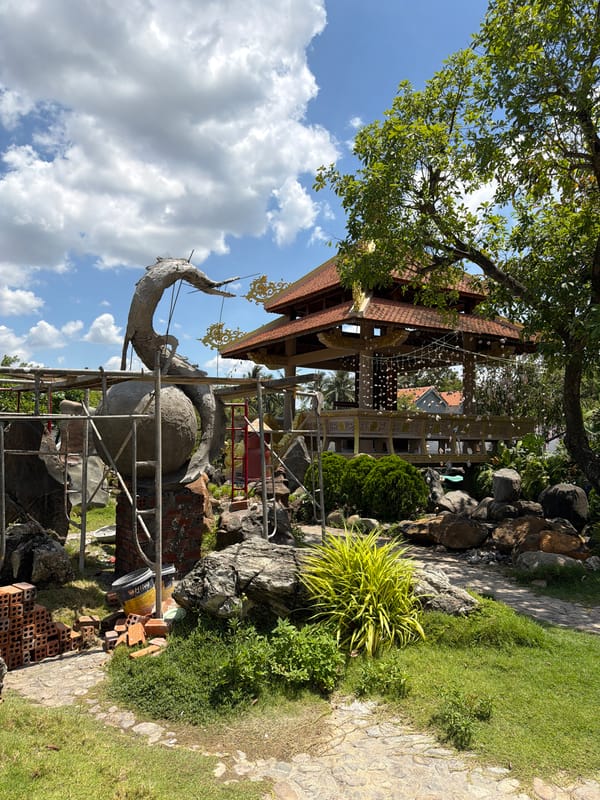 Inside a decorated Vietnamese temple complex with Buddhist and Hindu statuary