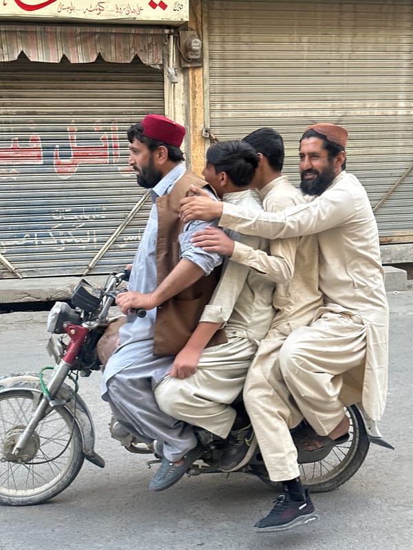 Four riders crammed onto one motorcycle in Quetta