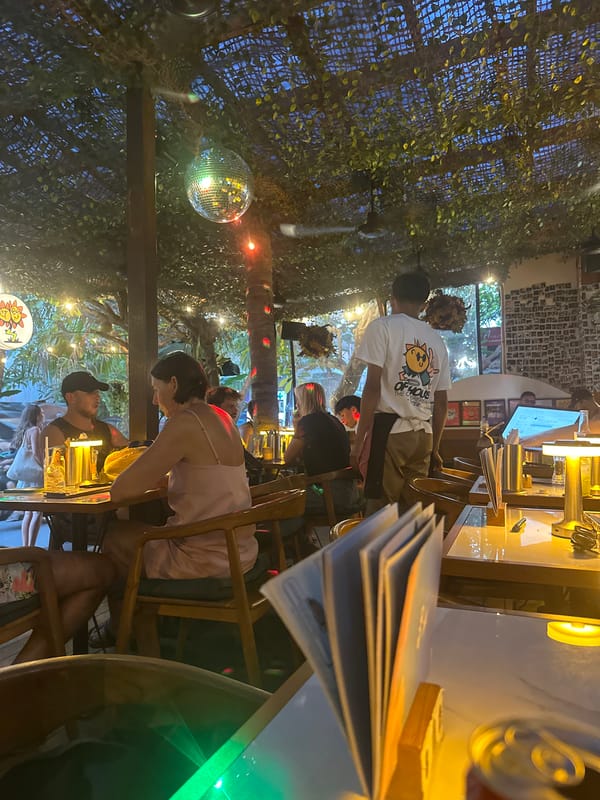 Burgers, fries, and cheesecake at a Mengwi restaurant