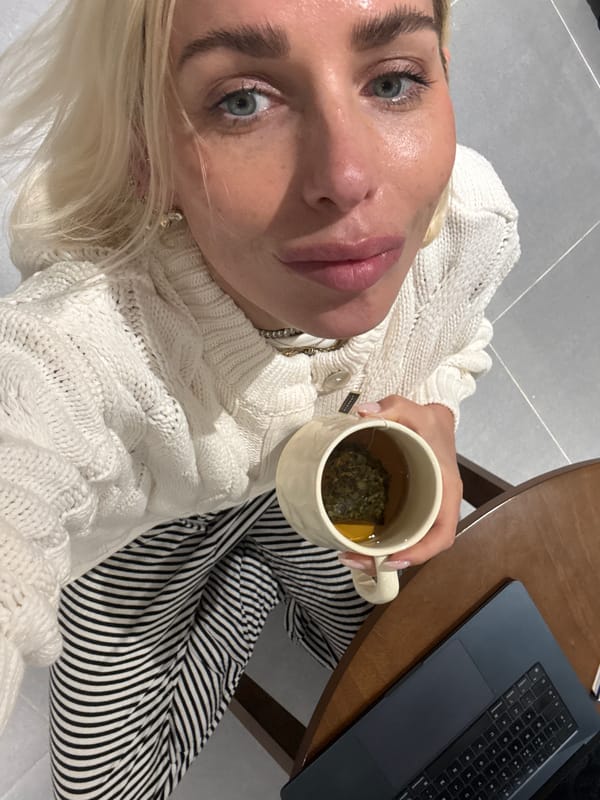 Person enjoys tea break with laptop in Dubai apartment