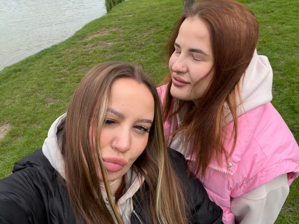 Two women photographed lying on grass in Krasnodar