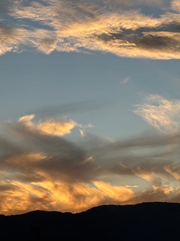 Sunset clouds over a silhouetted mountain range