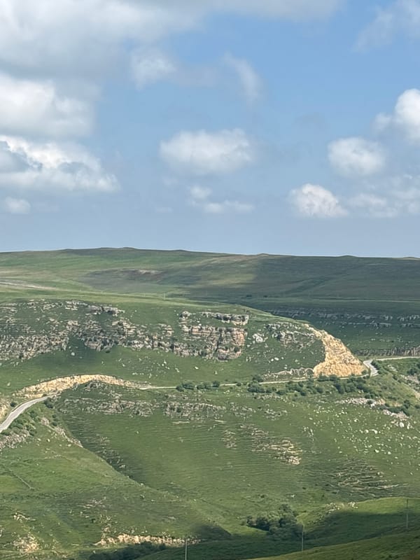Rolling highland scenery around a quiet Russian valley village