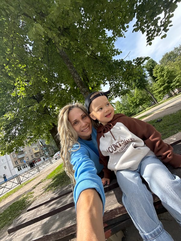 Woman and child share quiet moment on Russian park bench