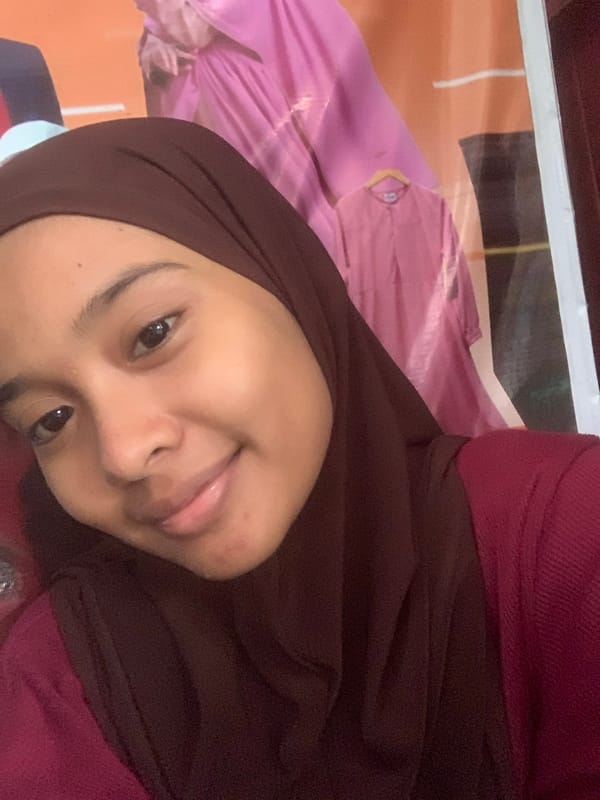 Young woman takes selfies in Sungai Meriam, Indonesia