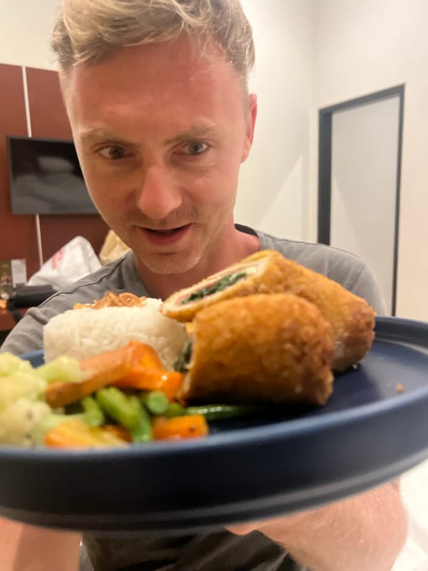 Man enjoys plated meal indoors in Kuta Selatan