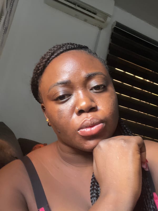 Woman takes morning selfies in Abuja bedroom