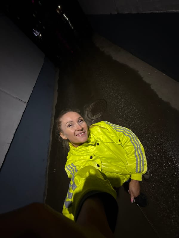 Woman walks dog through rainy Perm streets