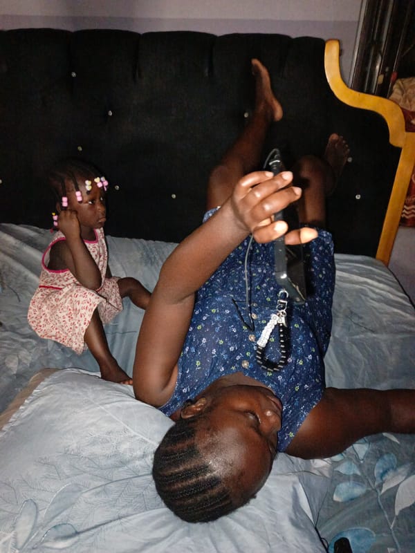 Woman and child share quiet moment on bed in Akwanga