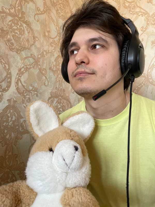 Person with headset lies beside plush rabbit in Izhevsk