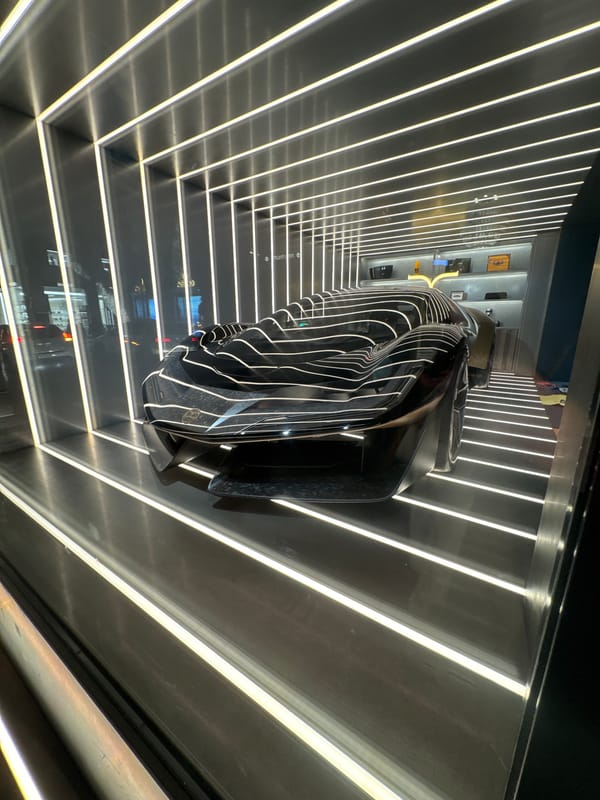 Abstract automotive sculpture spotted in reflective Milan space