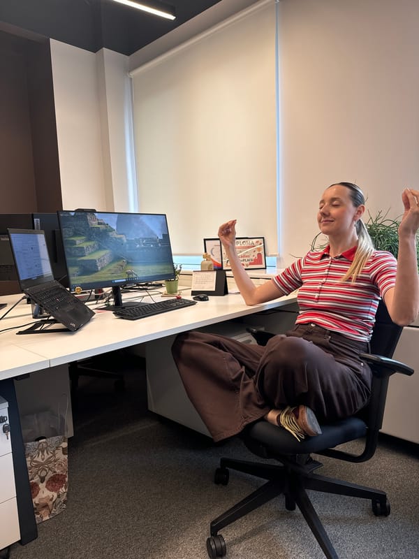 Office worker meditates at desk in Riga workplace