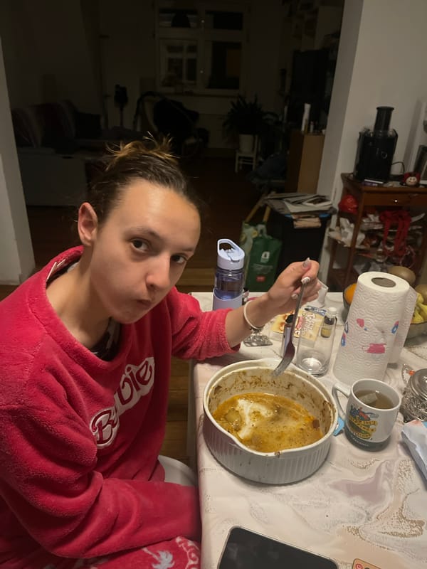 Woman in pink Barbie jacket enjoys meal in Saarbrücken