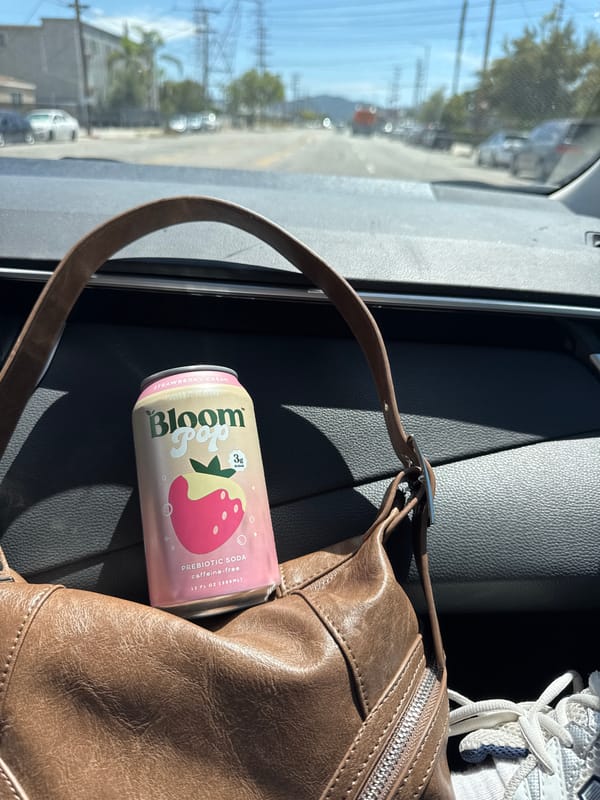 Person enjoys prebiotic soda inside car in Los Angeles