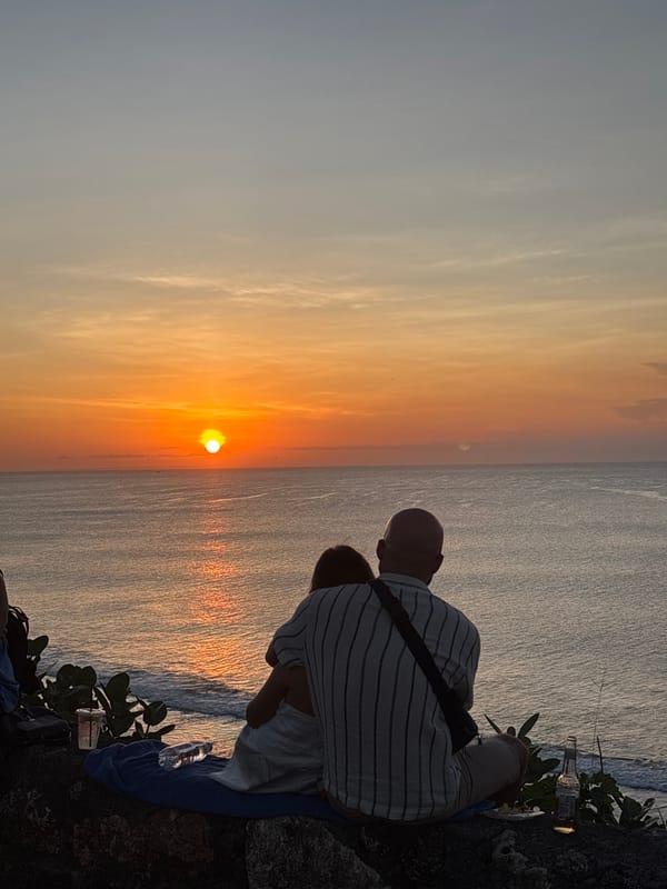 Sunset watchers gather at Uluwatu clifftops, wedding ceremony observed