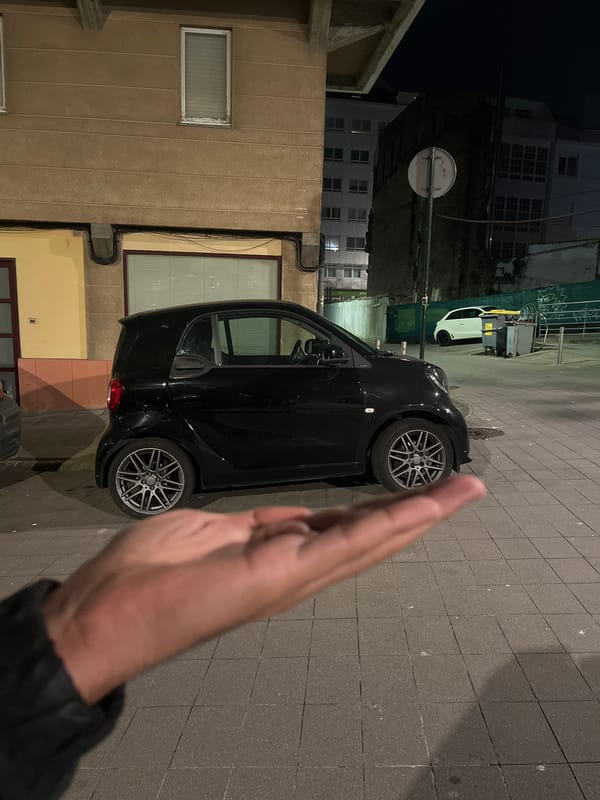 Smart car parked on cobblestone street in A Coruña