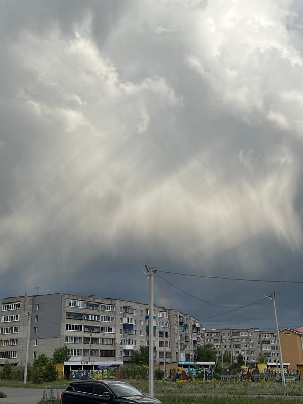 Overcast day captures Soviet-era apartments with playground area