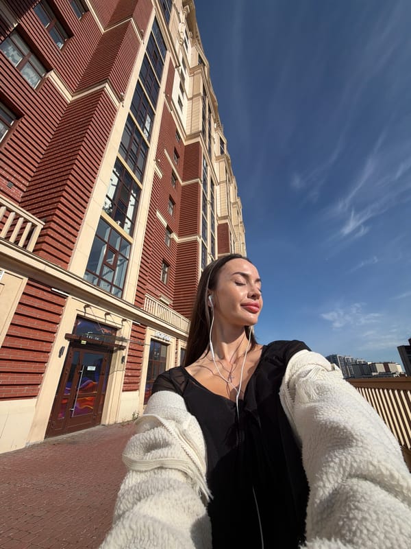 Selfies and street details outside a modern Russian building