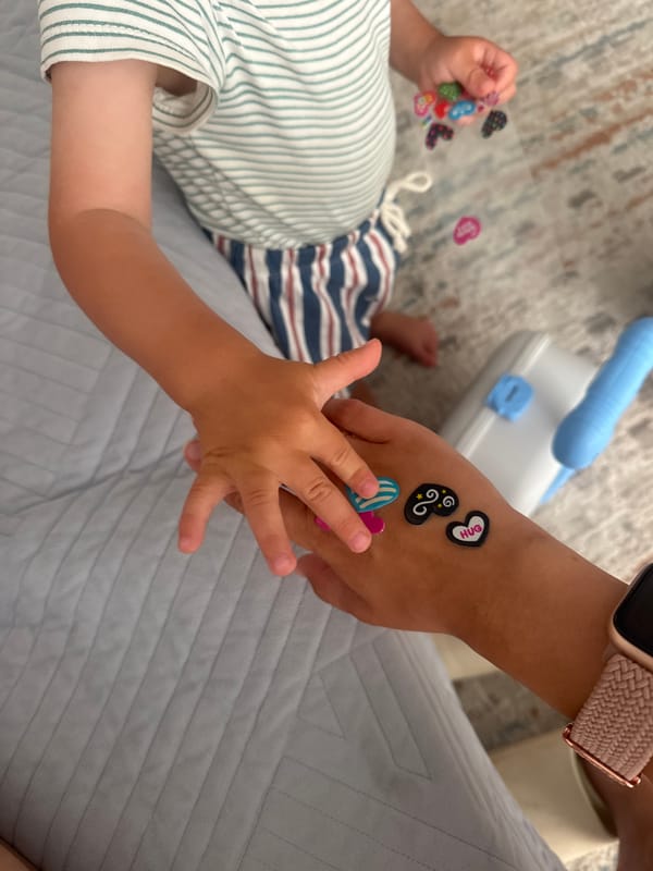 Child shares stickers with adult in Bat Yam