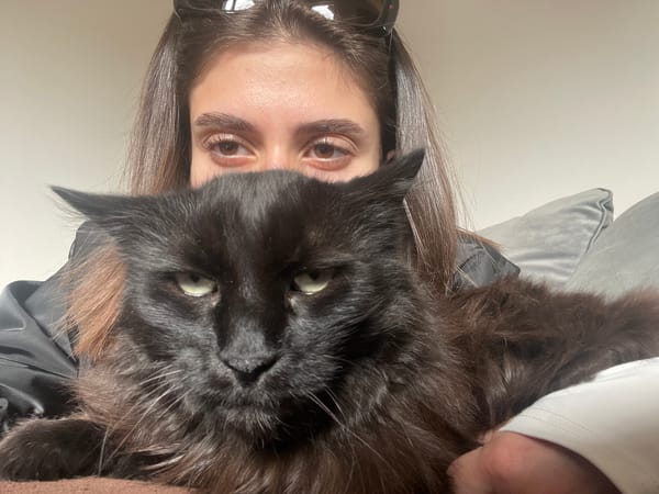 Woman and black cat pose for indoor portraits in Sofia