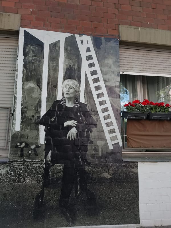 Museum visitors document German history exhibits and street murals