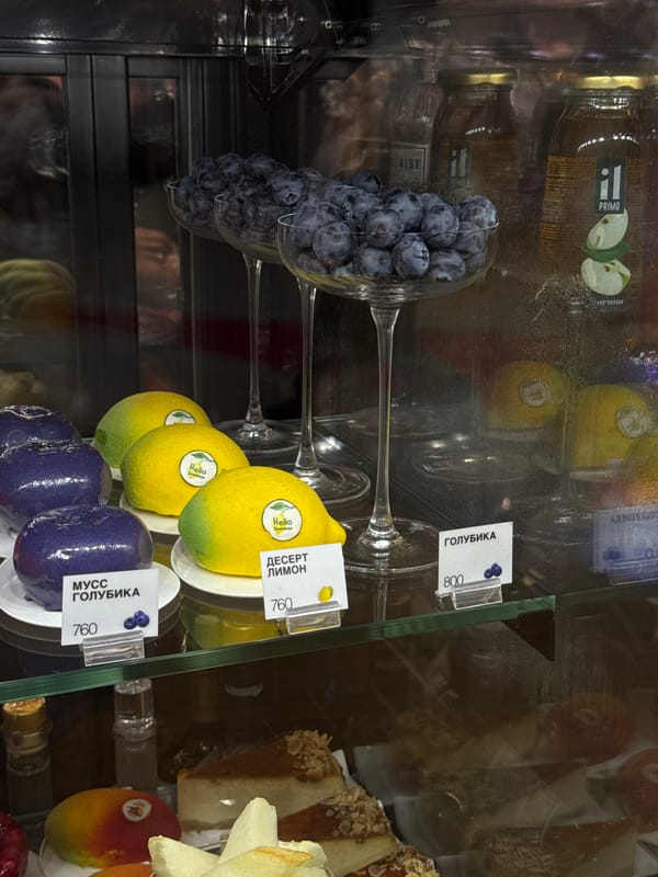 Dessert display case packed with pastries and fruit in Khimki