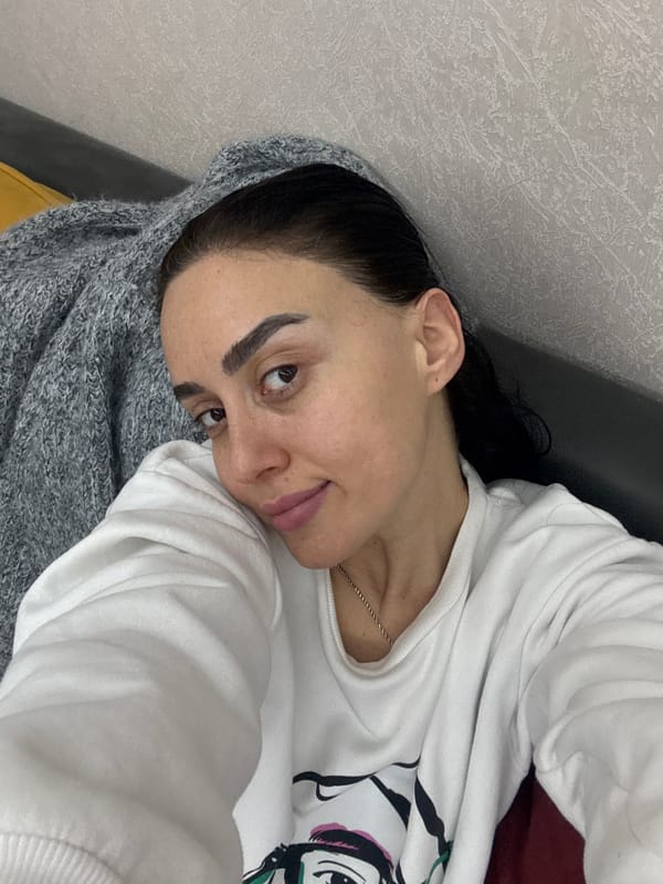 Woman photographed relaxing indoors in Tbilisi apartment setting