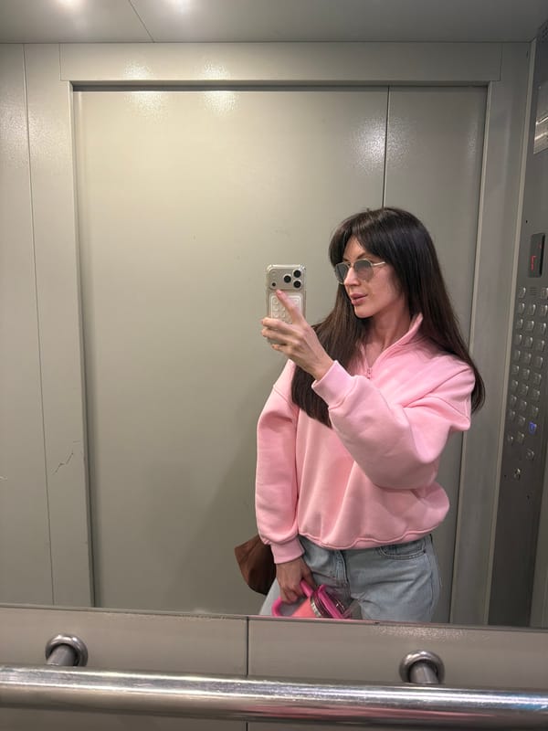 Person takes elevator selfies in pink outfit in Perm