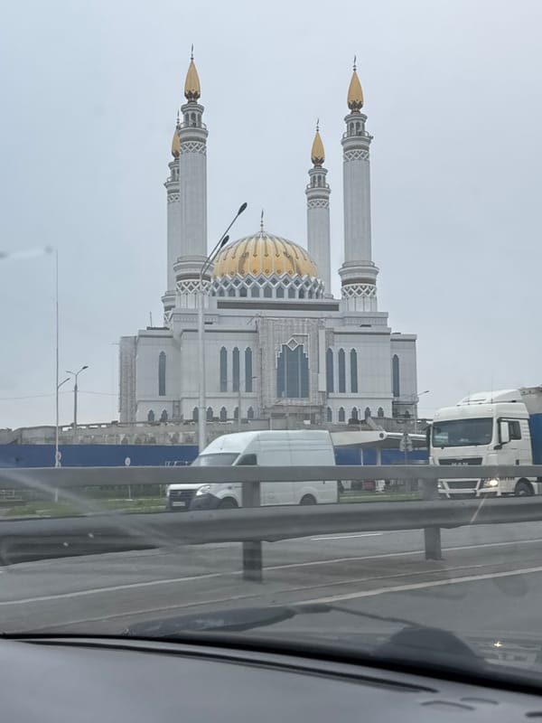 Ufa's prominent mosques, gold domes and minarets under cloudy skies