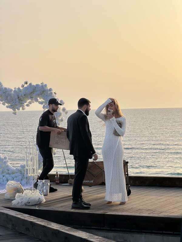 Three people gather on wooden pier in Bat Yam
