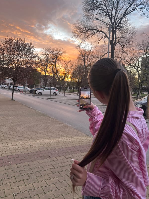 Woman captures sunset photo near monument in Nova Zagora