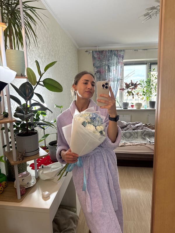 Woman Takes Mirror Selfie With Flower Bouquet in Russia