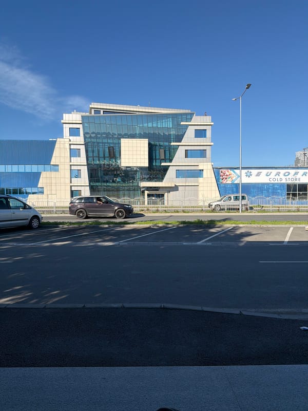 Modern building and parked cars observed in Plovdiv street