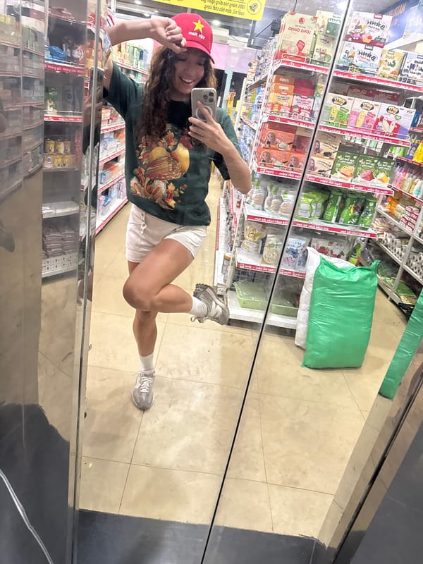 Tourist takes mirror selfie in Vietnamese store wearing patriotic cap