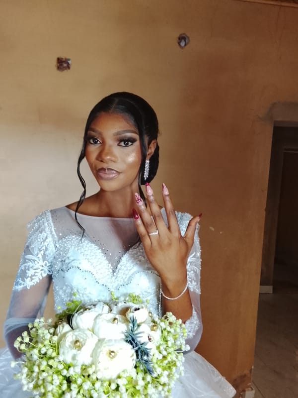 Bride photographed with floral bouquet in Jos, Nigeria