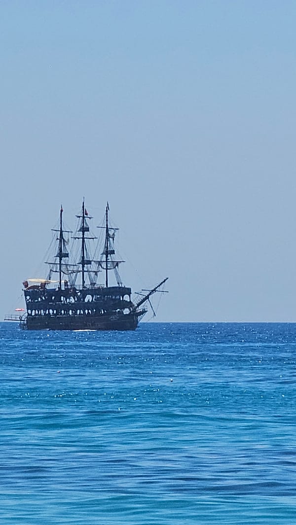 Alanya coastline in full summer swing — beach, sea, and sky.
