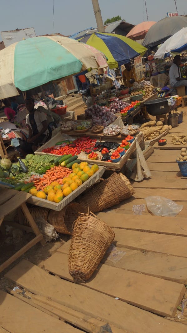 Outdoor market bustles with fresh produce in Ado Nigeria
