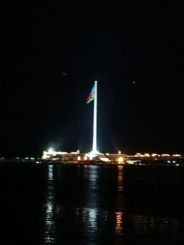 Baku Flagpole and Caspian skyline lit up at night
