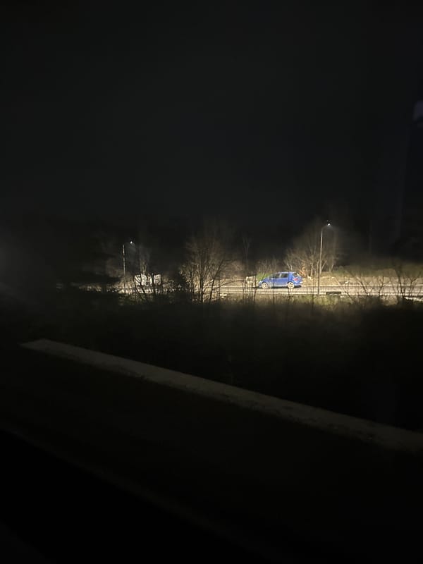 Blue car parked on nighttime street in Tsarevo