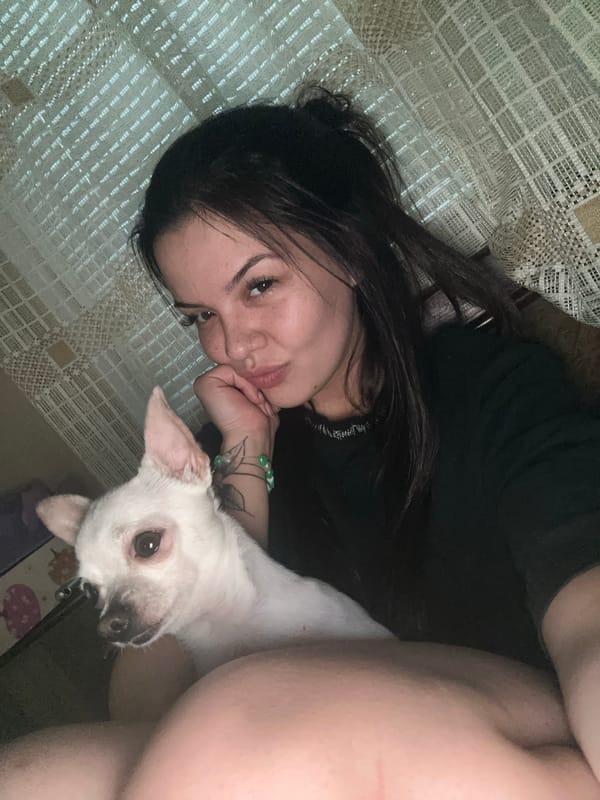 Woman and small white dog share quiet moments indoors