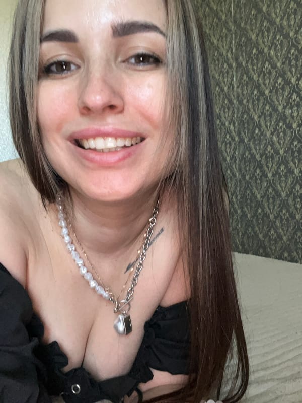 Woman in black top and pearls documented in 20 memories