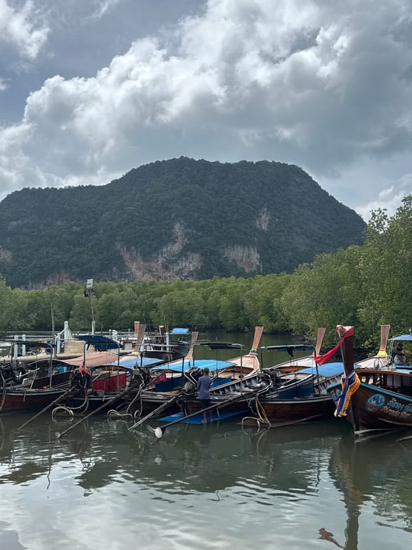 Longtail boats at a quiet pier in Ban Hin Rom, Thailand
