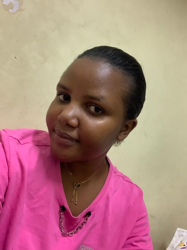 Woman poses for photos in pink shirt in Dar es Salaam