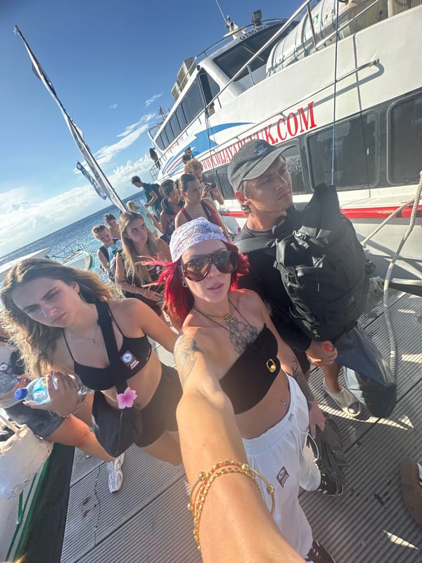 Tourists enjoy boat tour selfies off Nusa Penida coast