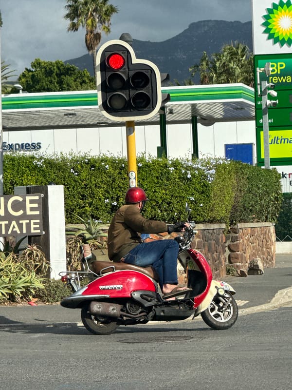Red scooter rider stops at Hout Bay traffic light