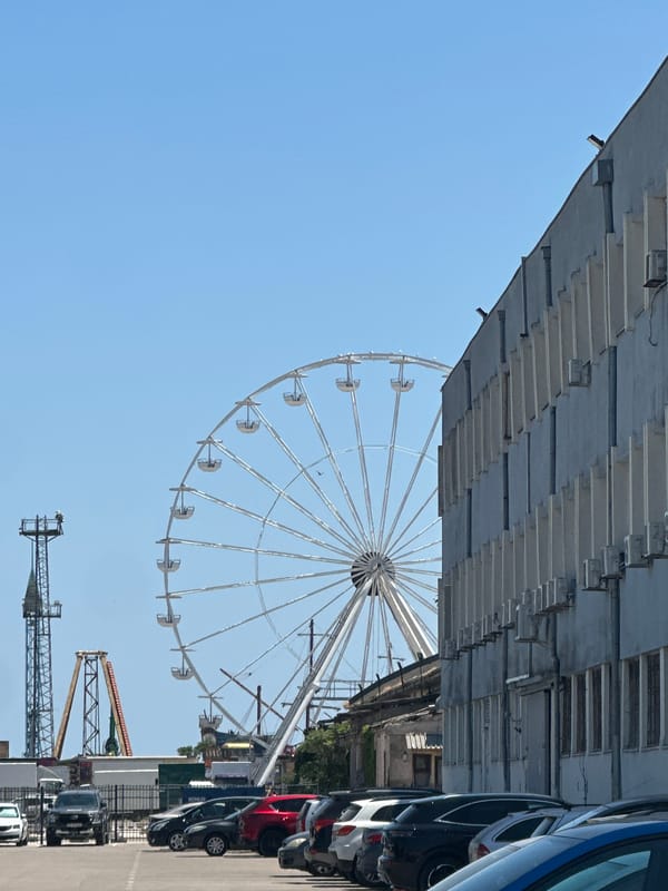 Industrial port cranes and waterfront landmarks on a clear morning