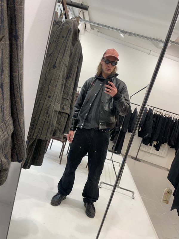 Shopper browses Paris fashion boutique, takes mirror selfie