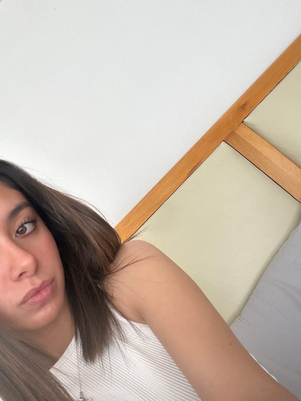 Woman takes selfies in bedroom during evening hours